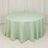 Green gingham round tablecloth on a plain backdrop.