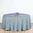 Round gray tablecloth draped over a table set for dining.