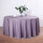 Purple round tablecloth draped over a table with floral arrangement