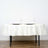 Elegant white tablecloth draped on a table set for two with plates and glasses.