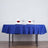 Elegant blue tablecloth with white napkins and roses on a dining table.