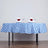 Blue and white checkered tablecloth with rose-adorned napkins and wine glasses.