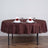 Elegant brown tablecloth with white napkins and red roses set for dining.