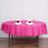 Pink round tablecloth with elegant napkin and rose centerpiece set for dining.