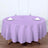 Purple round tablecloth on a dining table with utensils and glasses