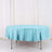 Round turquoise tablecloth on a table in a bright setting.