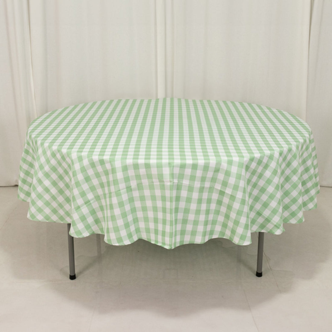 Green and white checkered tablecloth on a round table
