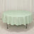 Green and white checkered tablecloth on a round table