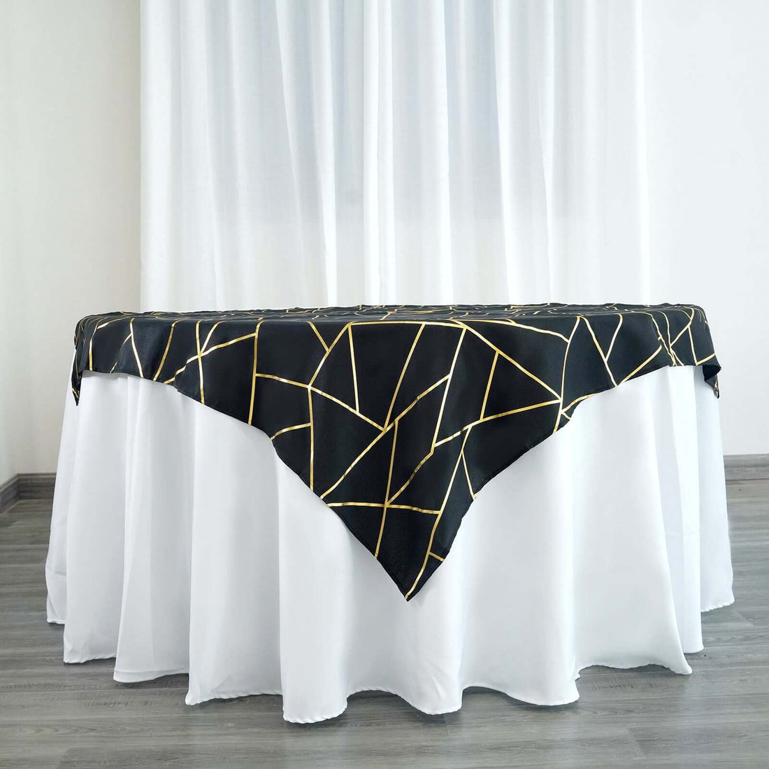 Black and gold geometric table runner on a white tablecloth
