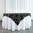 Black and gold geometric table runner on a white tablecloth