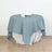 Round blue tablecloth draped elegantly over a white lace table.