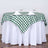 Green and white checkered tablecloth on a round table set for dining.