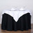 Table set with white and black linens, glasses, and napkins for an elegant dining experience.