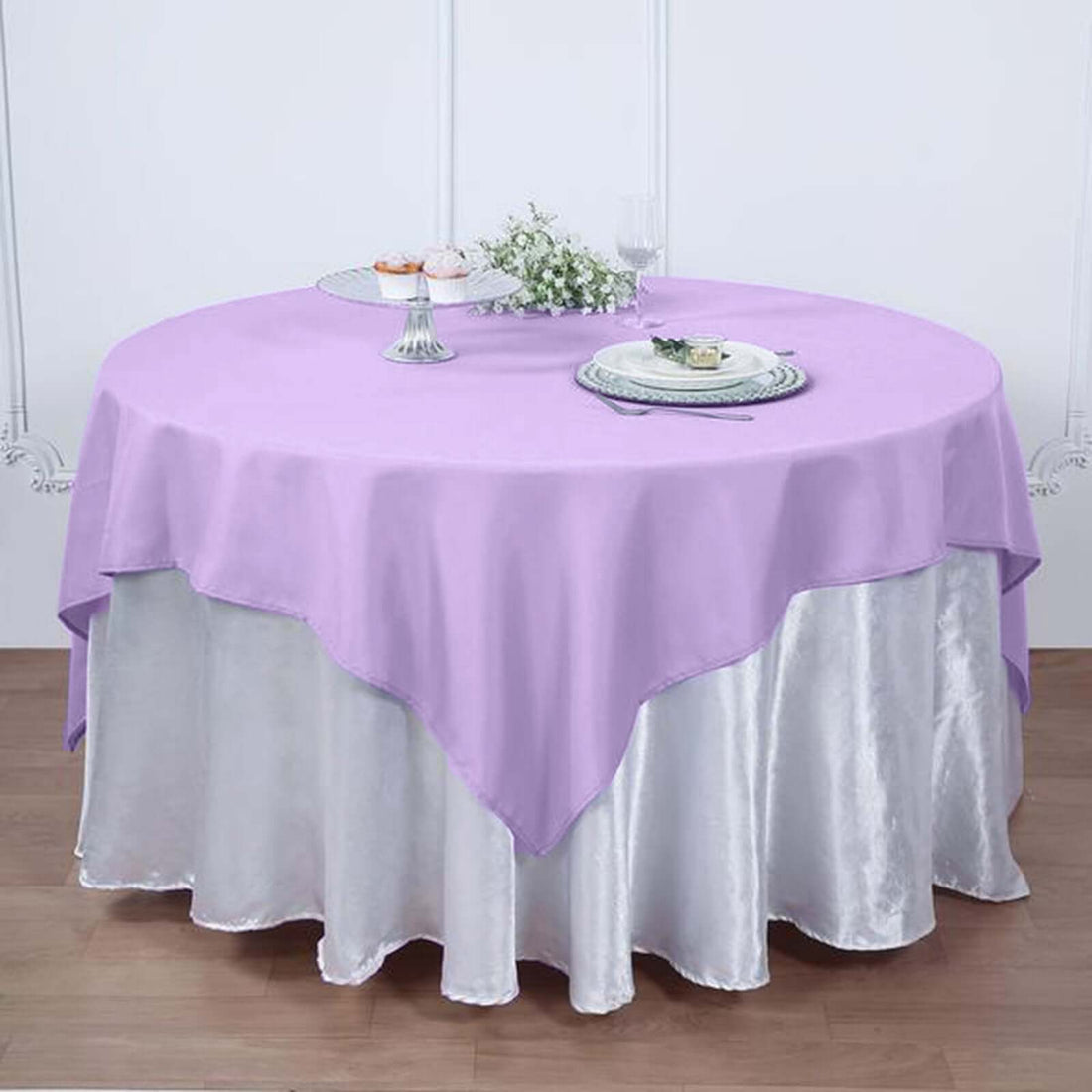 Round lavender tablecloth draped elegantly over a silver table cover.