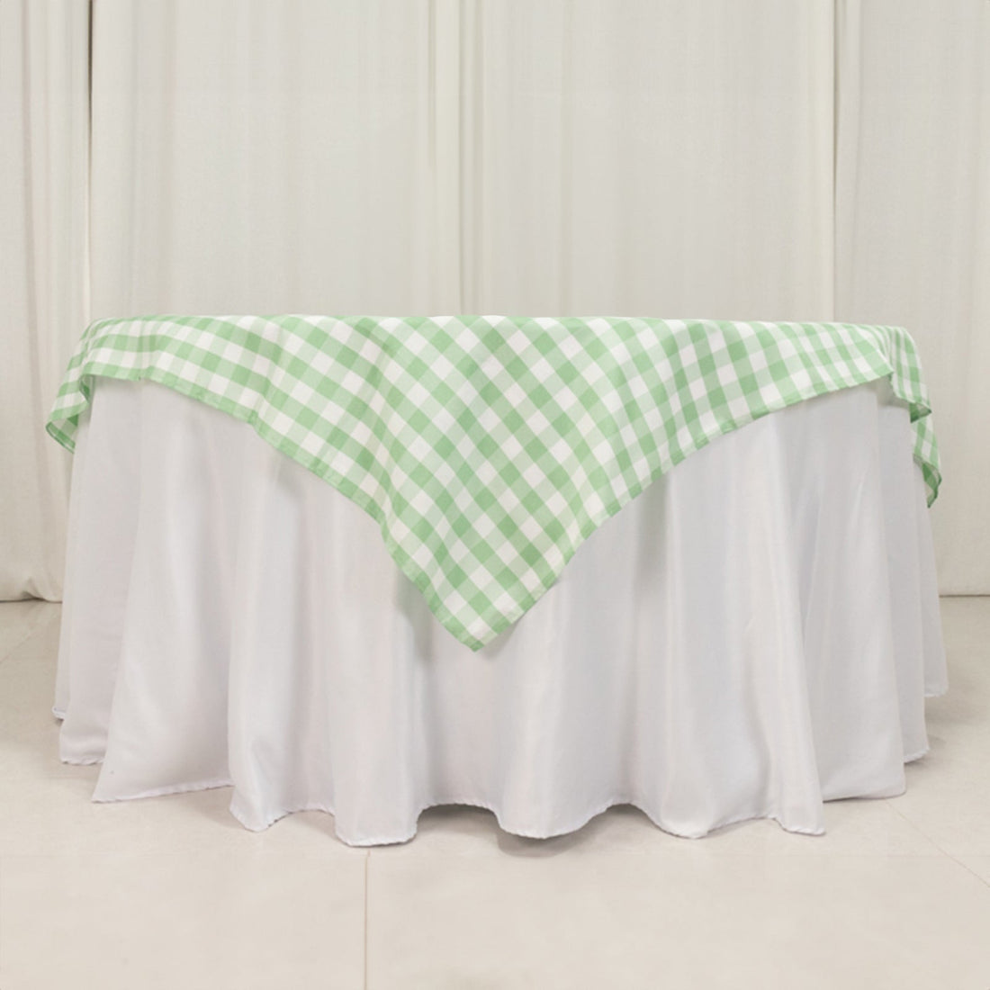 Green checkered tablecloth draped over a white table.