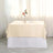 Beige tablecloth draped elegantly over a white table, styled with a vase and cup.