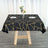 Black tablecloth with gold geometric design on a wooden table.