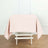 Pink tablecloth draped over a white wooden table in a simple setting.