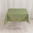 Green tablecloth with gold abstract design on a white table.