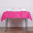 Pink tablecloth draped over a table set with glasses and napkins.
