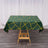 Green tablecloth with geometric yellow pattern on wooden table.