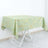 Green tablecloth with gold geometric pattern on a white table
