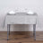 Gray tablecloth set with glasses and napkins on a wooden floor.
