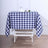 Blue and white checkered tablecloth on a wooden table.