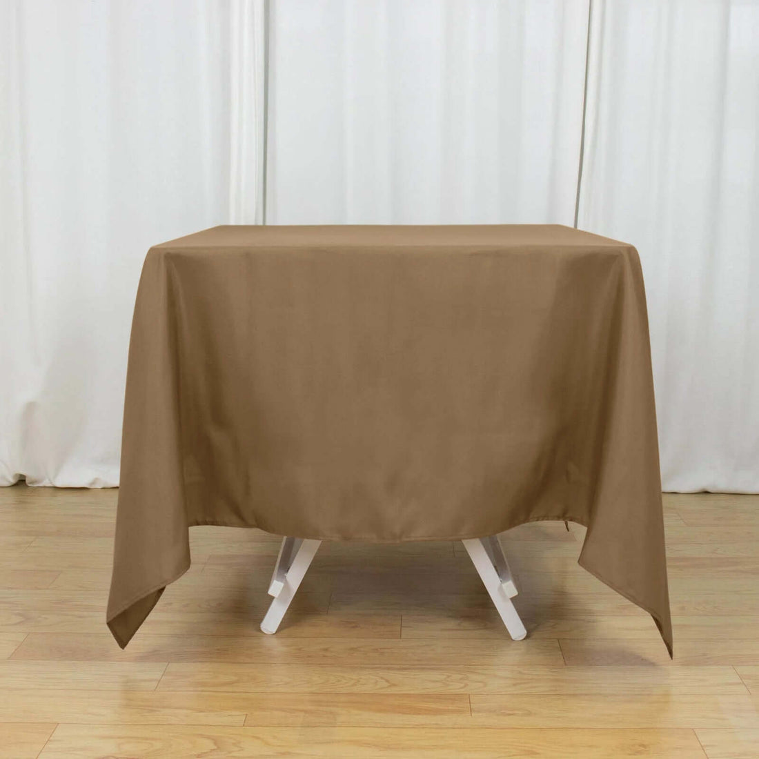 Brown tablecloth draped over a table in a studio setting.