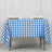 Blue and white checkered tablecloth on a table with cups and napkins.