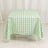 Green and white checkered tablecloth on a table.