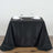 Elegant black tablecloth draped on a table set for dining.