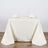 Elegant ivory tablecloth draped over a dining table with napkins and glasses.