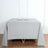 Gray tablecloth on a wooden table with candle holders