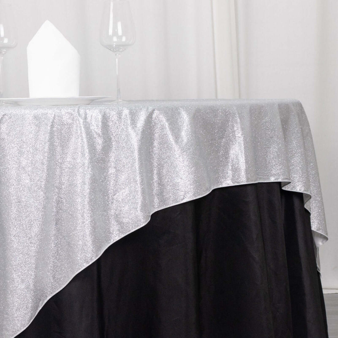 Shimmering silver and black tablecloth with elegant drape.