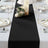 Black table runner on a beautifully set dining table with elegant decor.