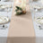 Elegant beige table runner on a beautifully set dining table.