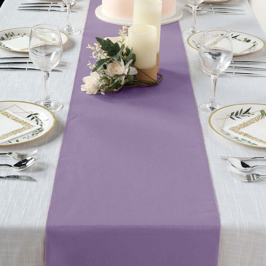Purple table runner on a dining table set for a meal with floral accents.