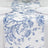 Blue floral table runner on a white table setting with plates.