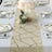 Elegant table runner with gold geometric design, set for a formal dining experience.