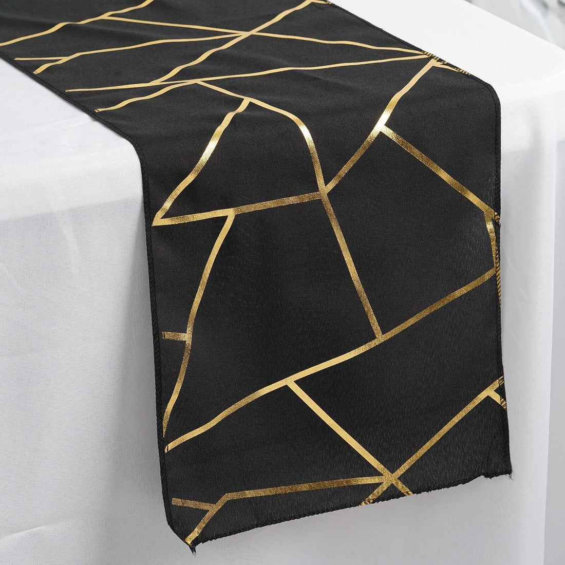 Black table runner with gold geometric pattern