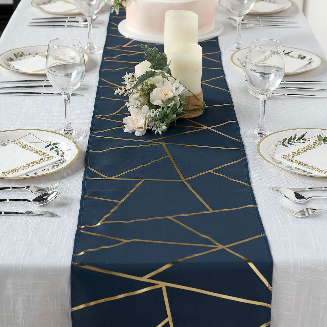 Elegant navy table runner with gold geometric design, styled for a dining table setting.