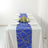 Elegant blue table runner with gold geometric design on a white table setting.