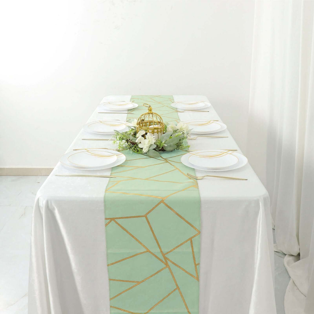 Table setting with mint green geometric runner and white plates.