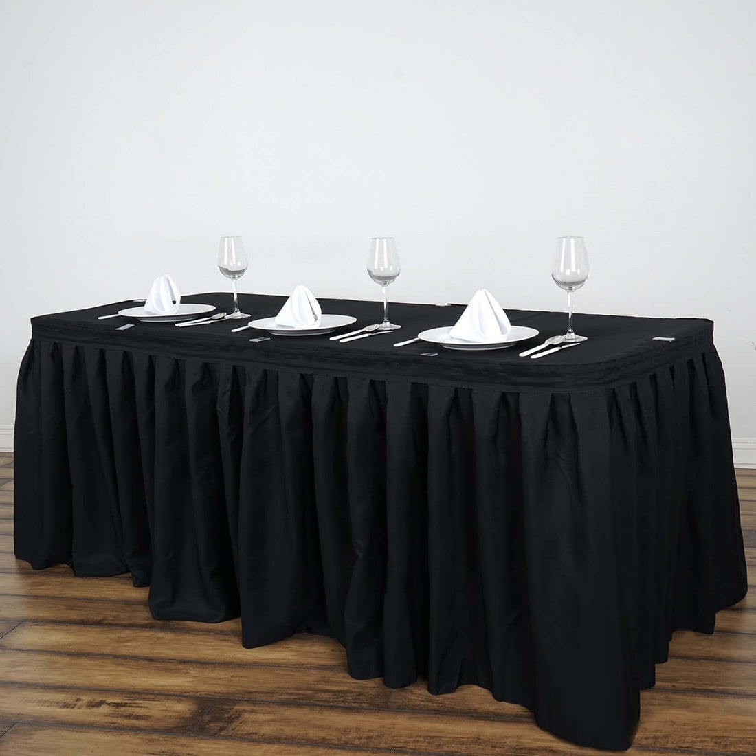 Elegant black tablecloth with dinnerware set for formal dining.