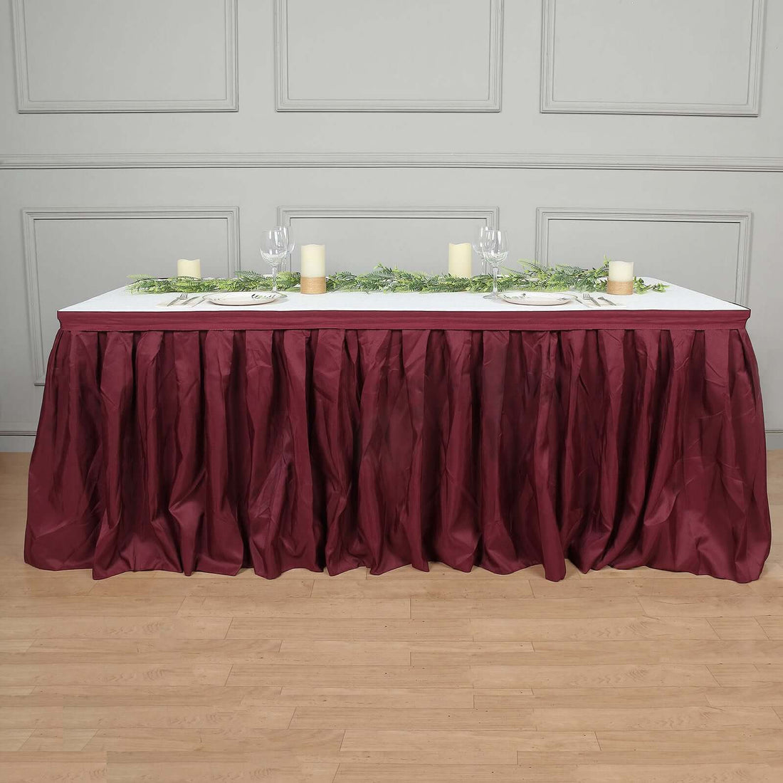Maroon table skirt with gathered design, ideal for events and gatherings.