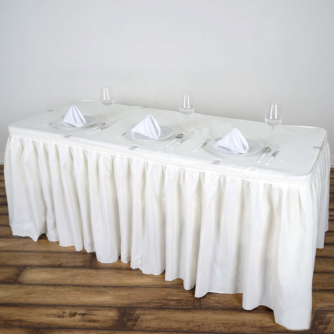 White table with elegant cloth and place settings for four.