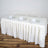 White table with elegant cloth and place settings for four.