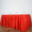 Red table skirt with glasses set for dining.