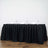 Black tablecloth draped over a long table set for dining with glasses and napkins.